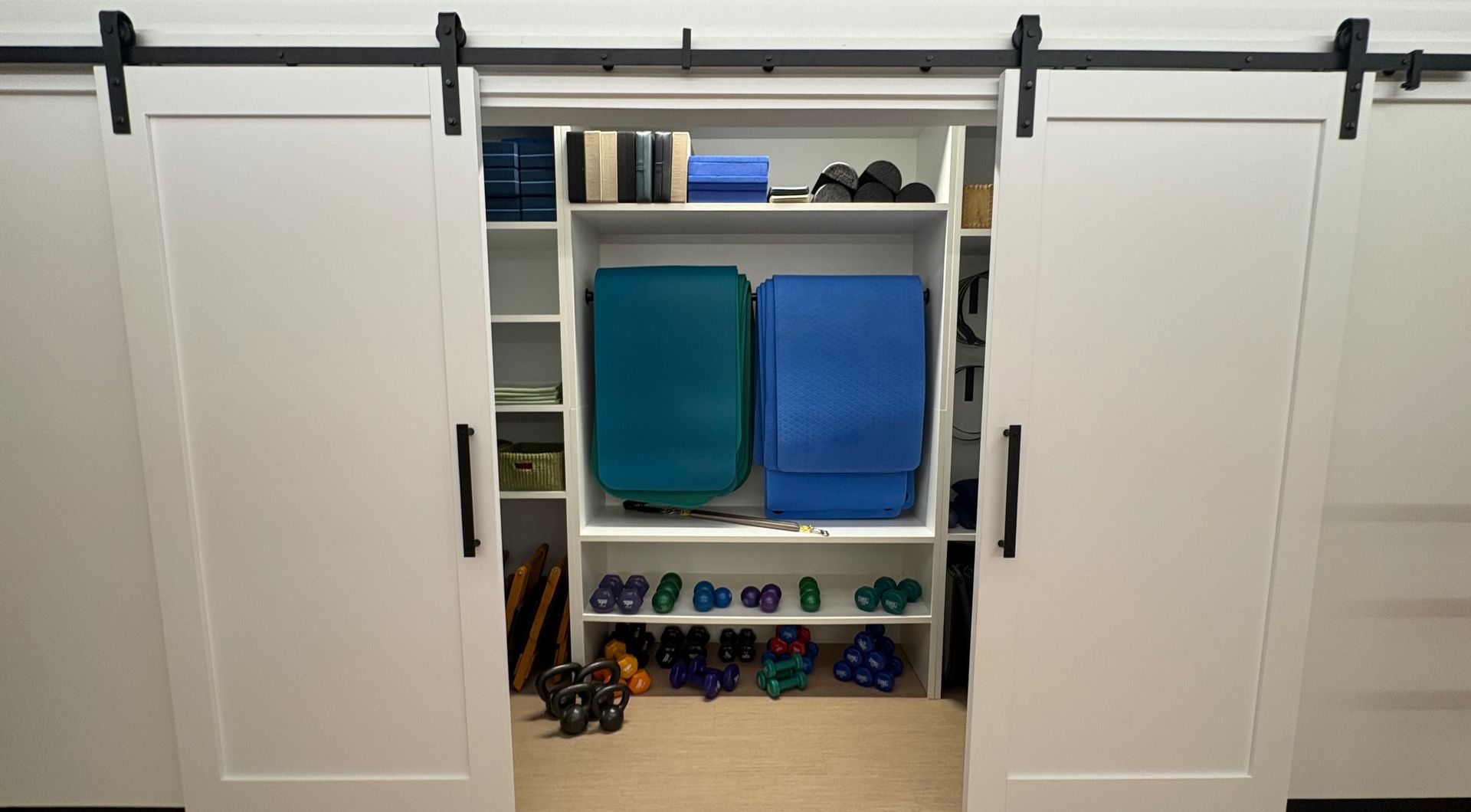 Spacious wooden closet with mirror reflecting modern minimalist style, perfect for home interior design.