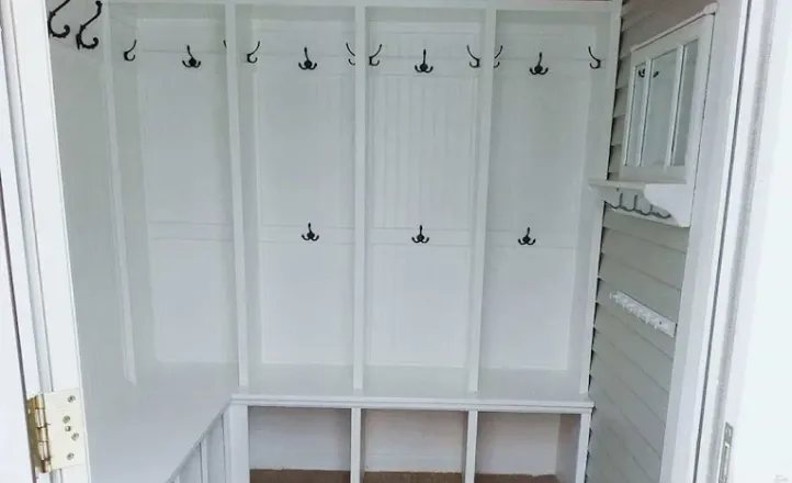 Bright minimalist staircase with wooden steps and metal handrail in a modern home interior.